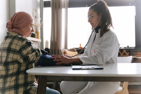 A female doctor taking a patients blood pressure