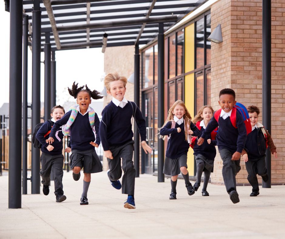 children running in to school happily