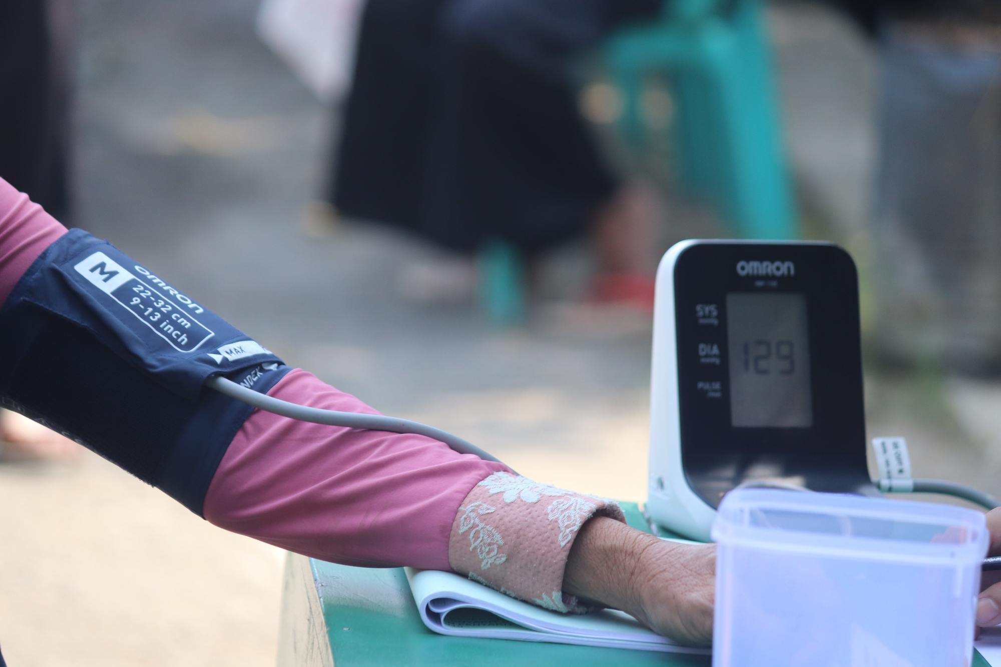 A person's arm and hand while having their blood pressure checked