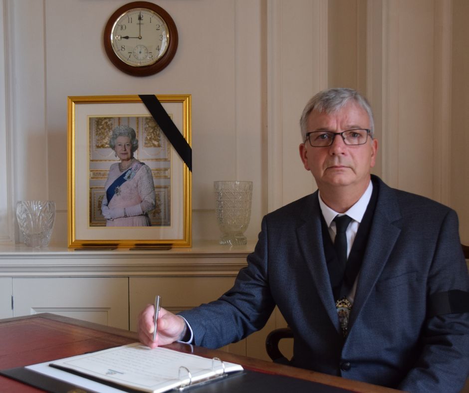 Ian Hall, Chairman of Devon County Council, signing Book of Condolences at County Hall