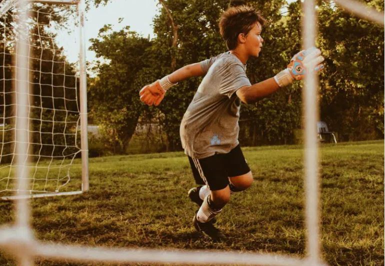 Boy in front of a goal in a park