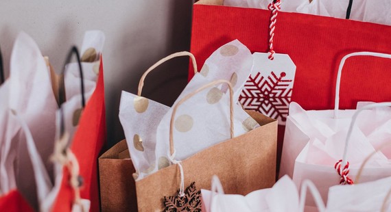 Paper gift bags with Christmas tags and wrapping paper