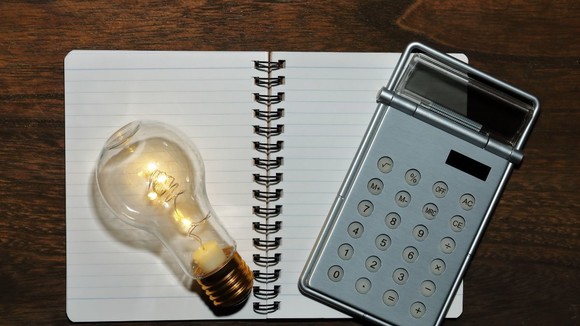 A notebook, light bulb and a calculator