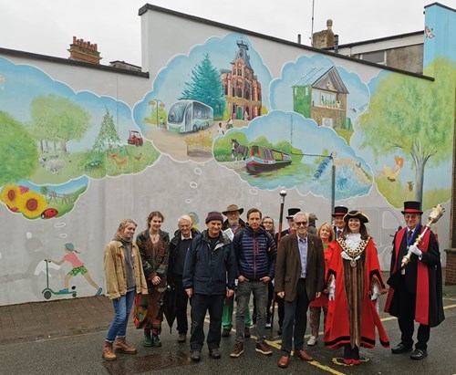 People gather to mark the completion of the Tiverton mural