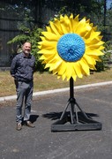 Atkinson's Head of Education, Glenn Wilce stands next to the sunflower