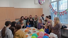 Children and adults celebrating a birthday.