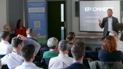A man presents to an audience at the launch of Decarbonise Devon