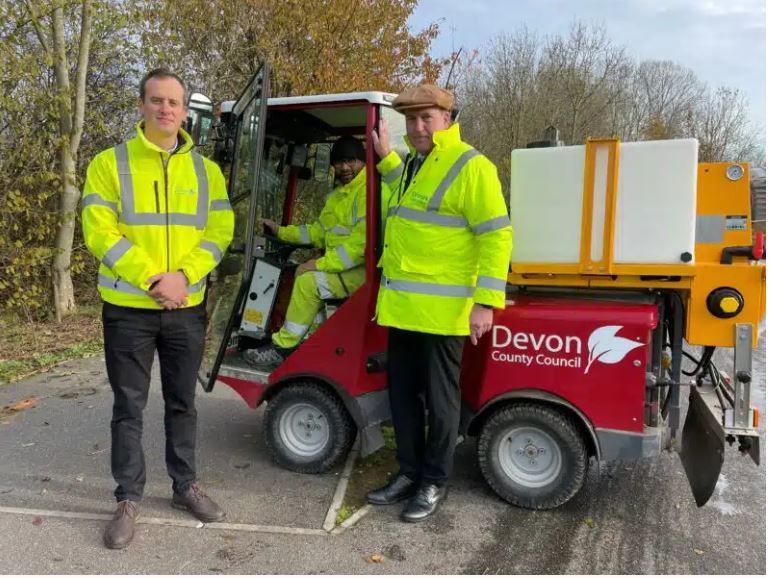 A small Powerflex vehicle alongside Cllr Hughes and officers from DCC