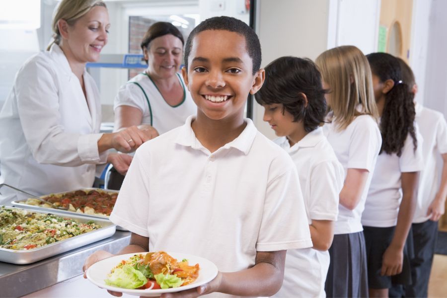 Boy smiling with school lunch