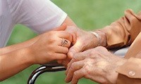 Care worker holding person hands