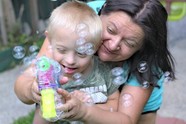 Mum and young child playing with bubbles