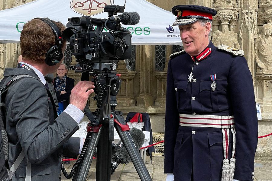 The Lord Lieutenant, David Fursdon, being interviewed by a reporter outside Exeter Cathedral for the Coronation service