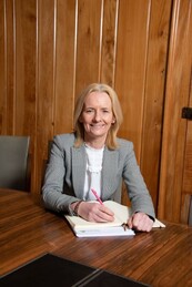 Donna Manson, Chief Executive, sitting at a table in the council chambers 