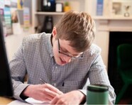 Picture of Luke Souster, a young man working at a desk