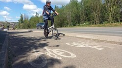 Woman cycling on a segregated cycle path