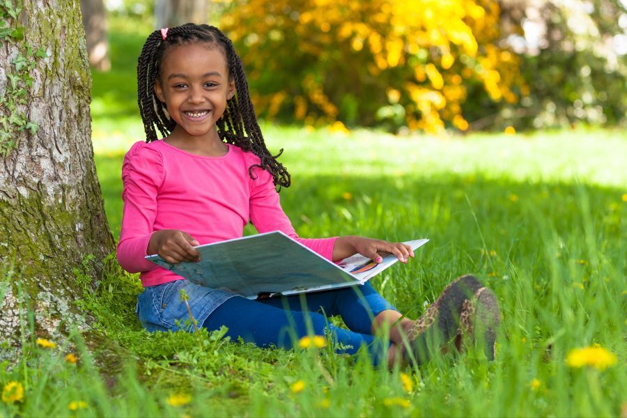 child reading outside