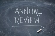 the words annual review on a chalkboard