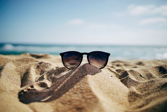 Beach and sunglasses Photo by Ethan Roberts on Unsplash