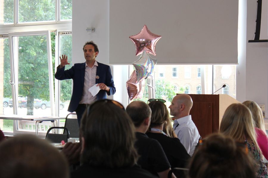 Manager, Nick Meller, speaking to people at the Y-Smart and REACH team celebration event