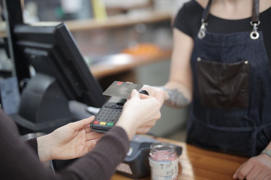 A cashier serving a customer and taking payment