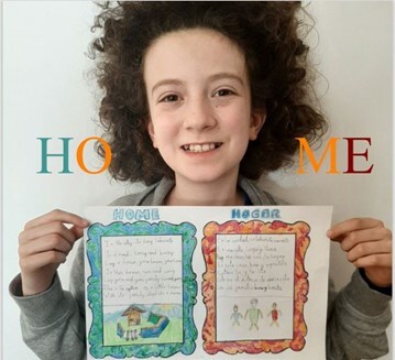 Child holding up home work