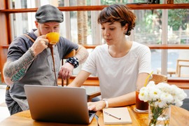 Adults having tea and working on the computer