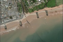 Visualisation of how rock groynes will look in Sidmouth - an aerial photo with protrusions of rock from the coast 