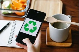 recycling symbol on phone next to coffee cup 