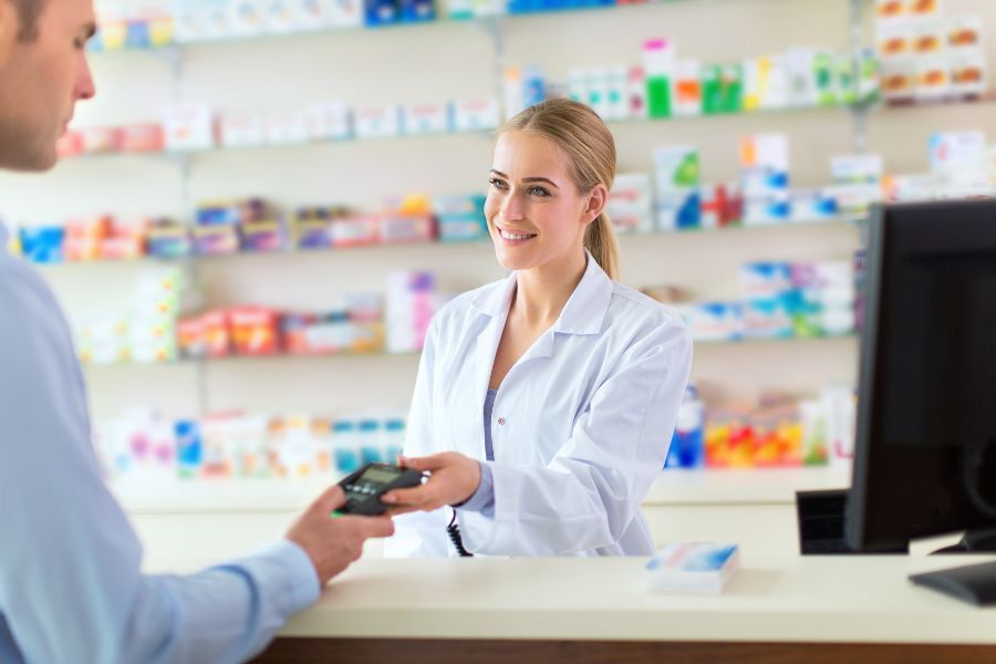 A pharmacist serving a customer