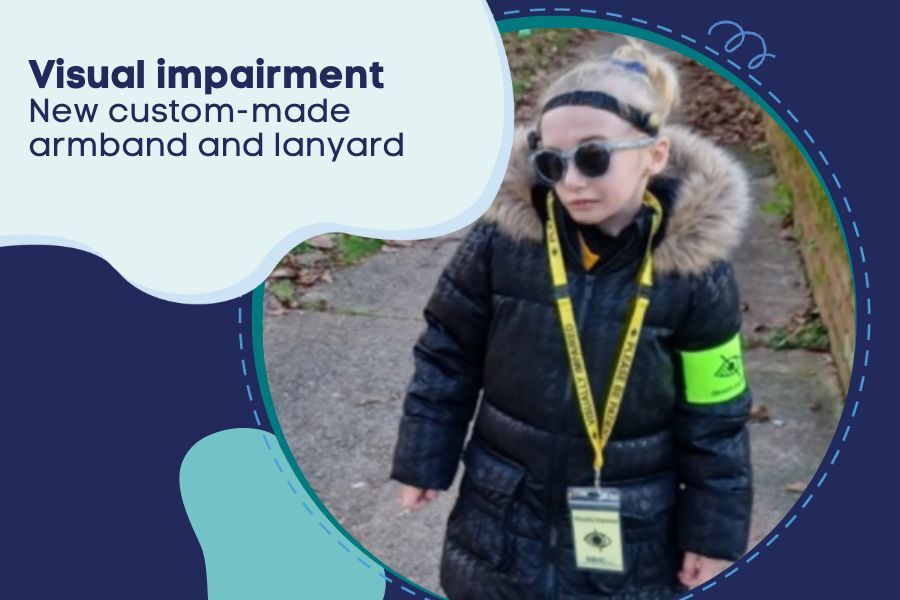 Child with a visual impairment wearing a new custom-made armband and lanyard