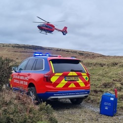 Devon air ambulance flying above Dartmoor