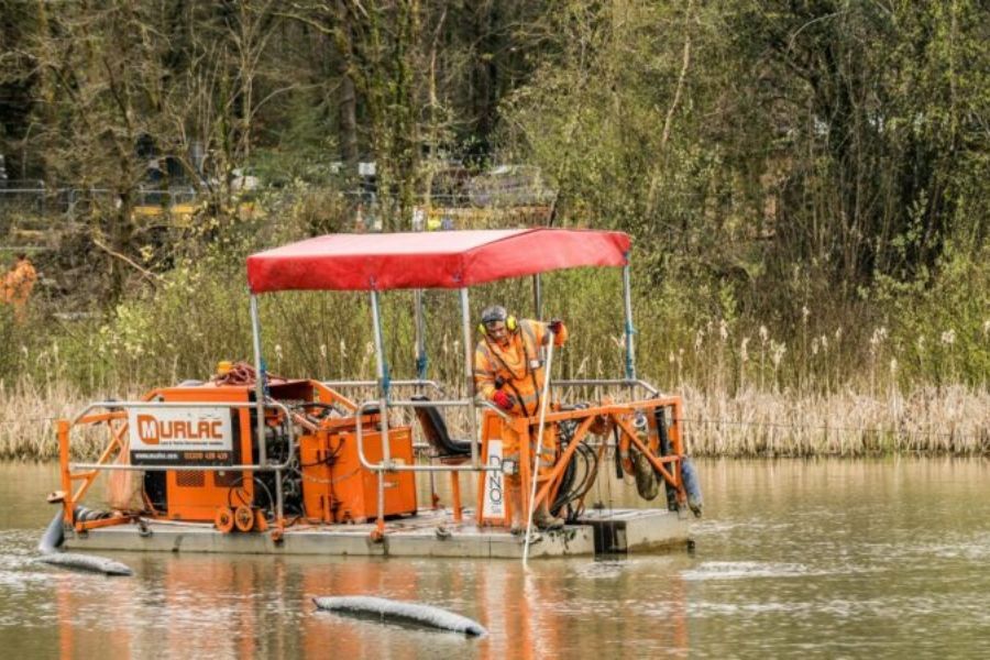 A floating maintenance vehicle/boat on the water at Stover Country Park