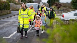 Volunteers and children taking part in a walking bus to school