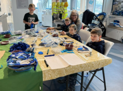 children sat around a table completing a craft activity