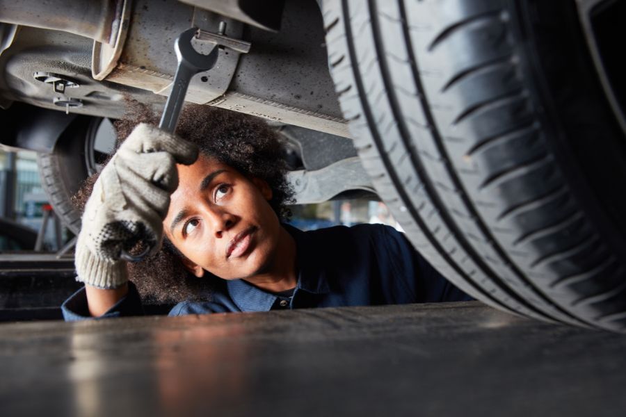 A young apprentice working as a mechanic in a garage