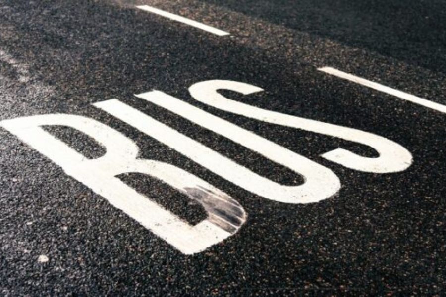A bus lane on the road, with the word 'Bus' painted on it.