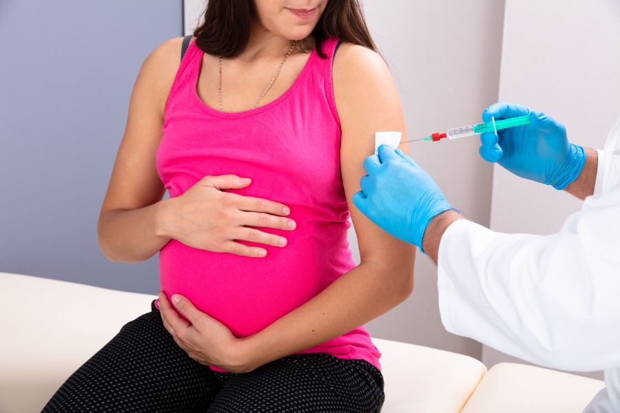 A pregnant woman receiving her vaccination