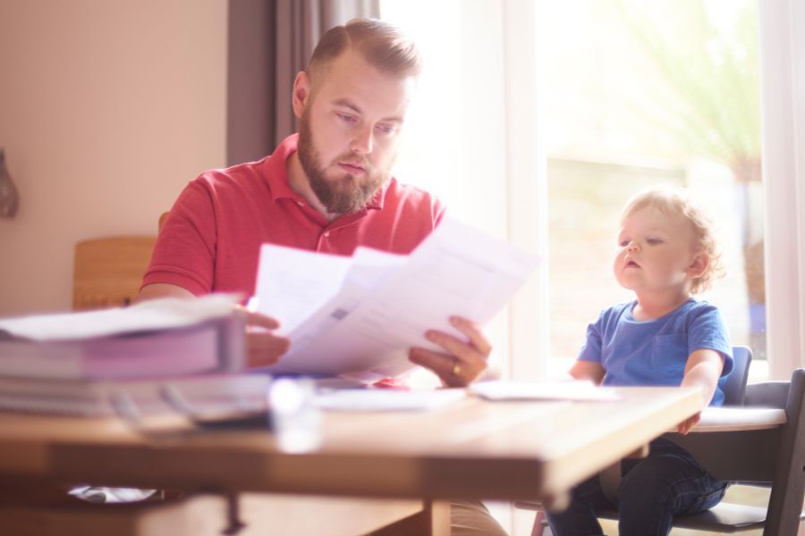 Parent looking at bills with child