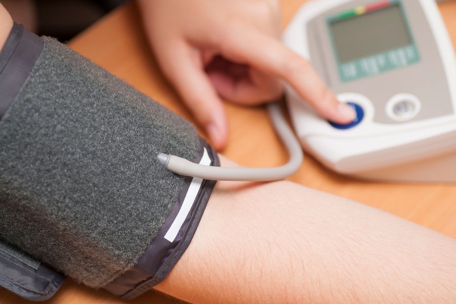 a person having their blood pressure taken using a machine