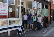 A group of people standing outside a shop