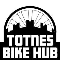 a silhouette of a wheel with a castle in front Totnes Bike Hub 