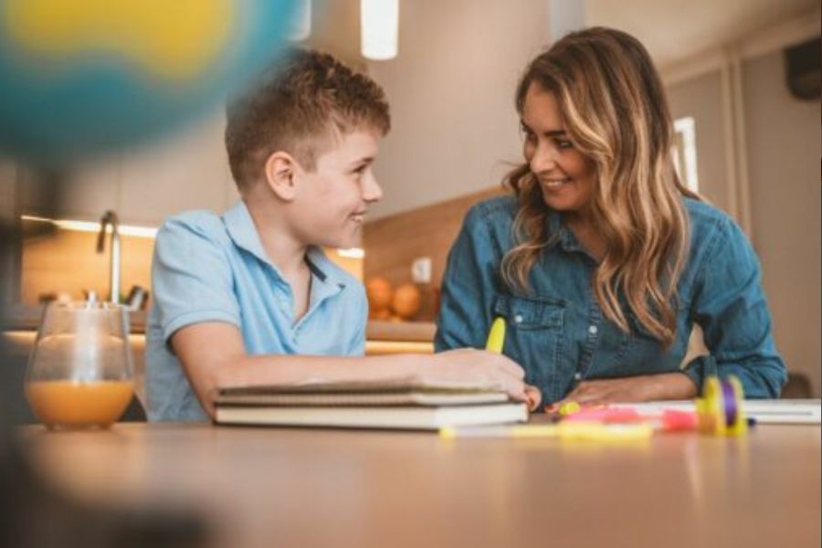 mother and son sat together at a table