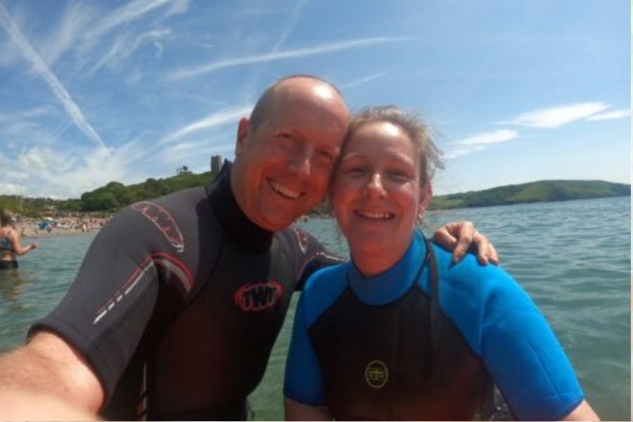 Ben Chambers and his wife Sarah on a workcation in Devon. A selfie photo taken of them on the beach.