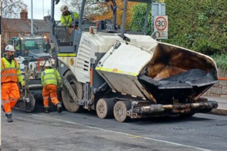 Highways repair workers in high vis jackets working on a road