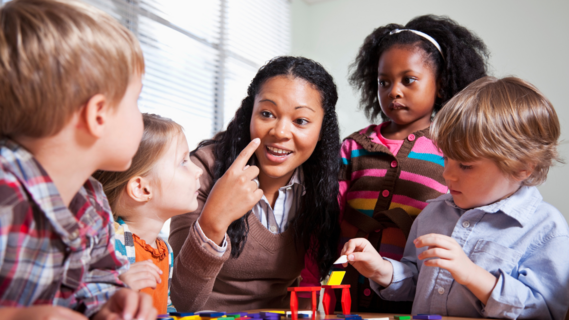 Group of children playing with an adult