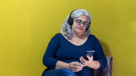 Woman listening to something looking at mobile screen