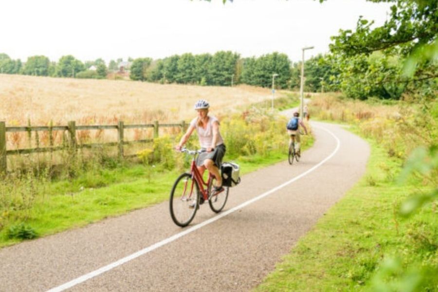 Two cyclists cycling on a cycle path