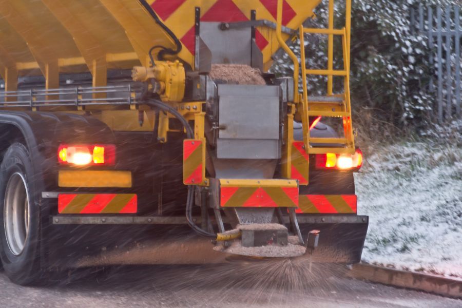 Gritter spreading on road