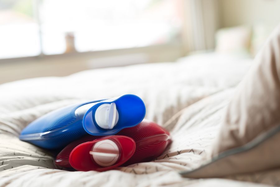 hot water bottles on a bed