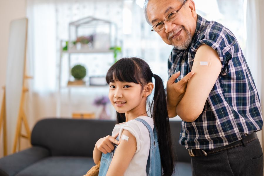 Elderly man and young girl with plaster on arm